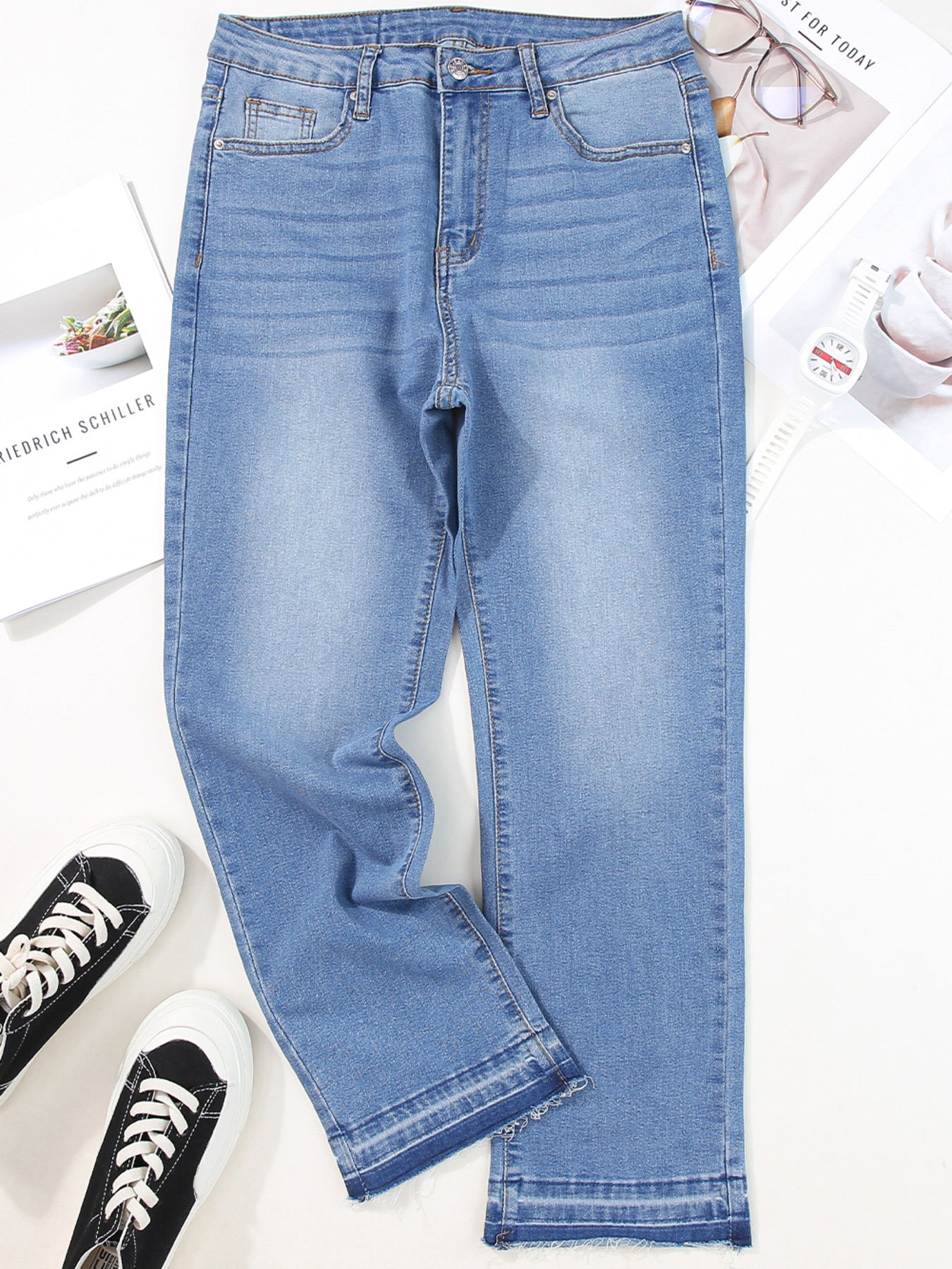 Light blue jeans with a white background and sneakers