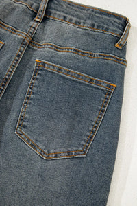 Close-up of a blue denim pocket on a white background