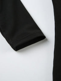 Close-up of black pants on a white background