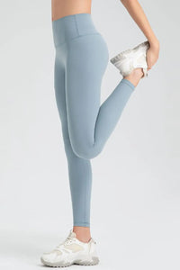 Light blue leggings worn by a person on a white background