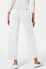 White jeans worn by a person on a white background