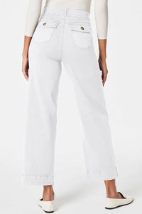 White jeans worn by a person on a white background