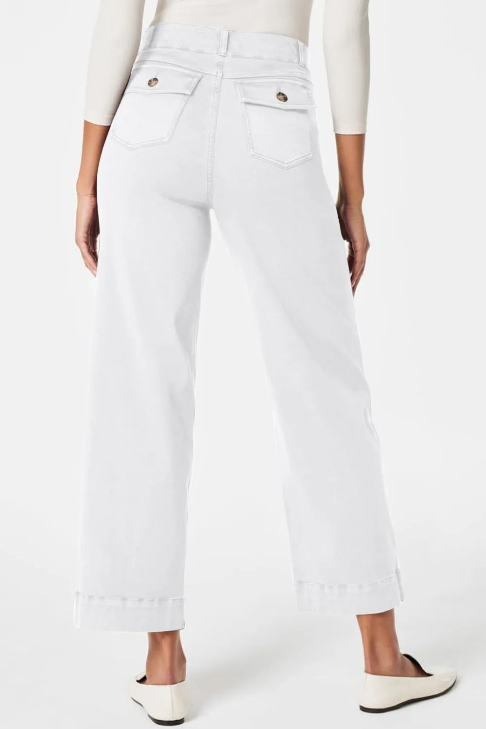 White jeans worn by a person on a white background