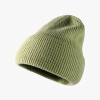Green knit beanie on a white background