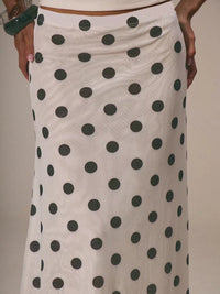 Polka dot skirt with black dots on a beige background