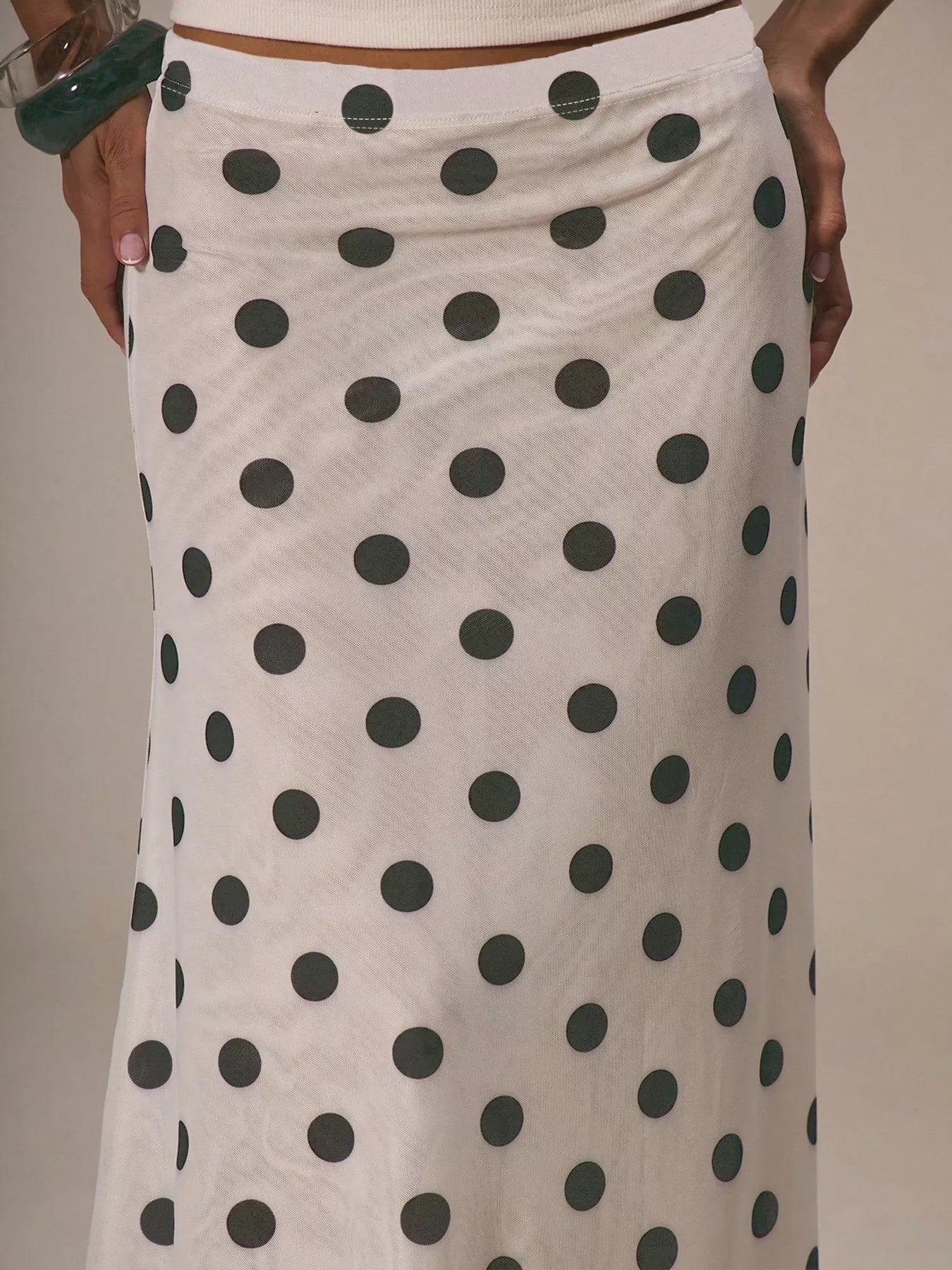 Polka dot skirt with black dots on a beige background