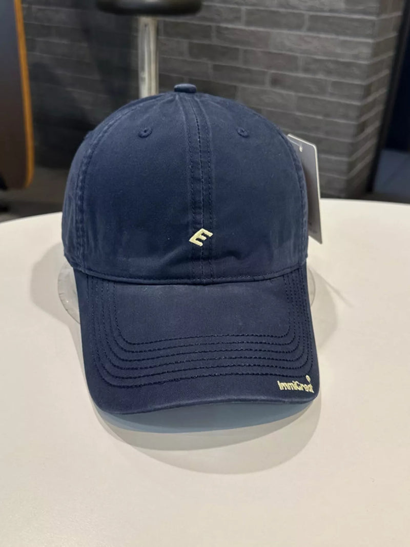 Blue cap with a logo on a white surface