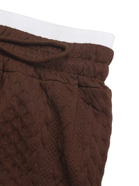 Brown textured pants with a white waistband on a white background