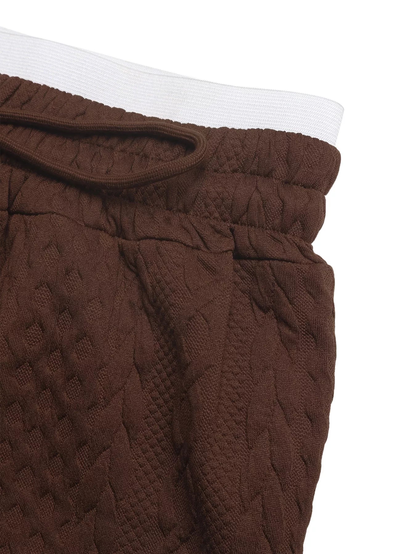 Brown textured pants with a white waistband on a white background