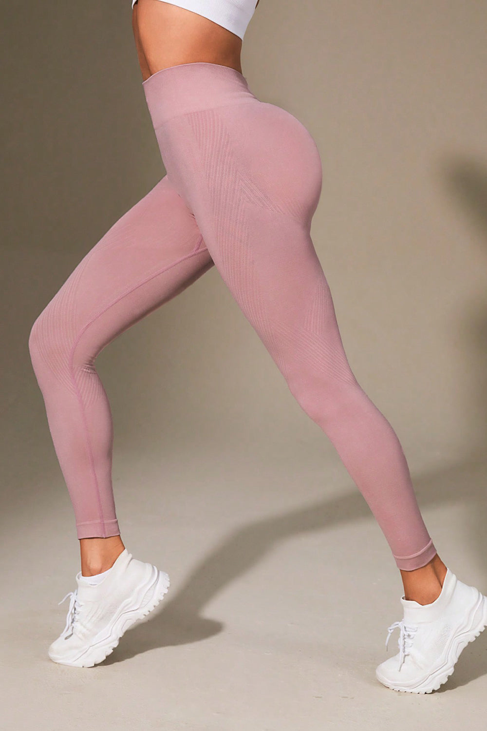 Pink leggings worn by a person on a beige background