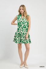 Woman wearing a green and white patterned dress on a white background