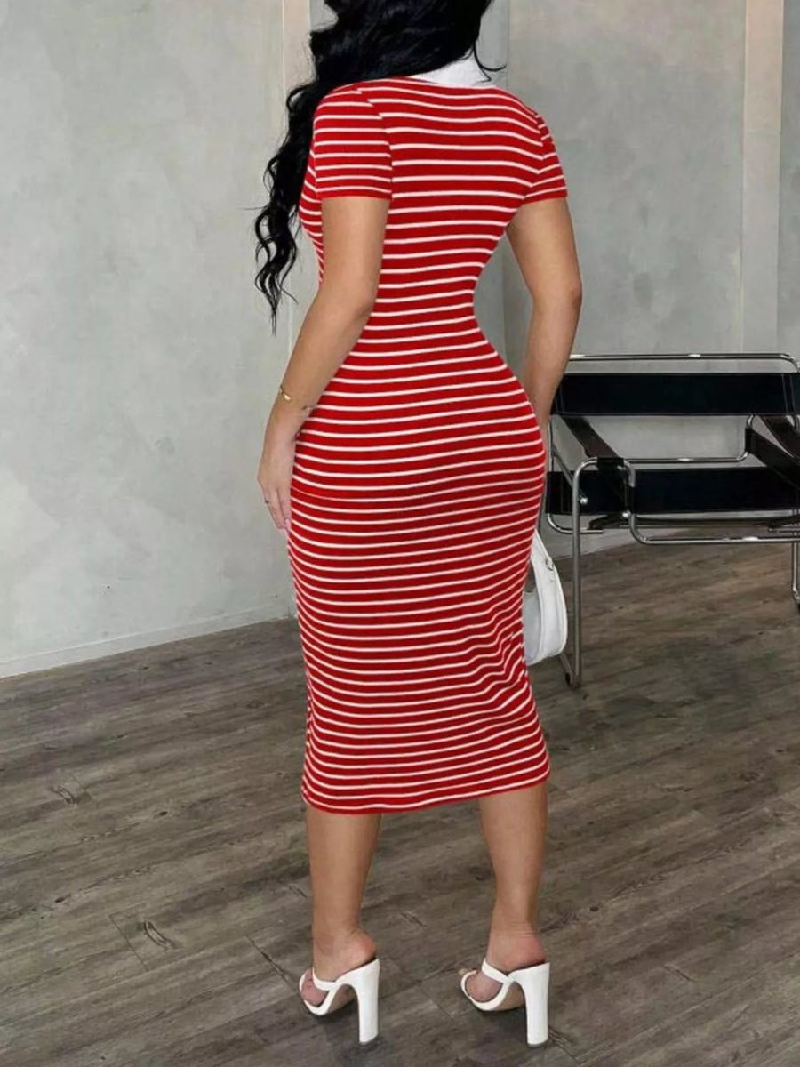 Person wearing a red and white striped dress in an indoor setting.