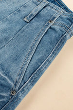 Close-up of blue denim jeans on a beige background
