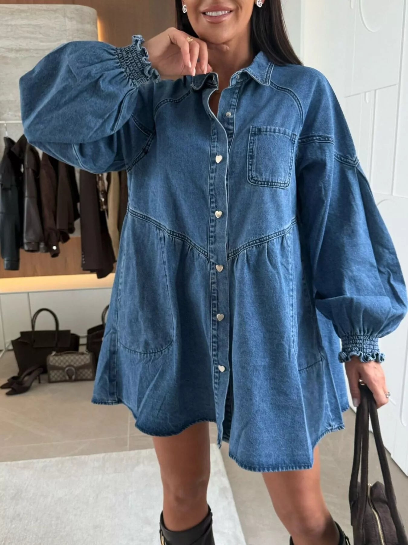 Woman wearing a blue denim dress in an indoor setting