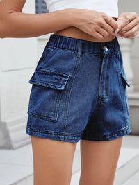 Person wearing blue denim shorts with a blurred background