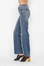 Blue jeans worn by a person on a white background