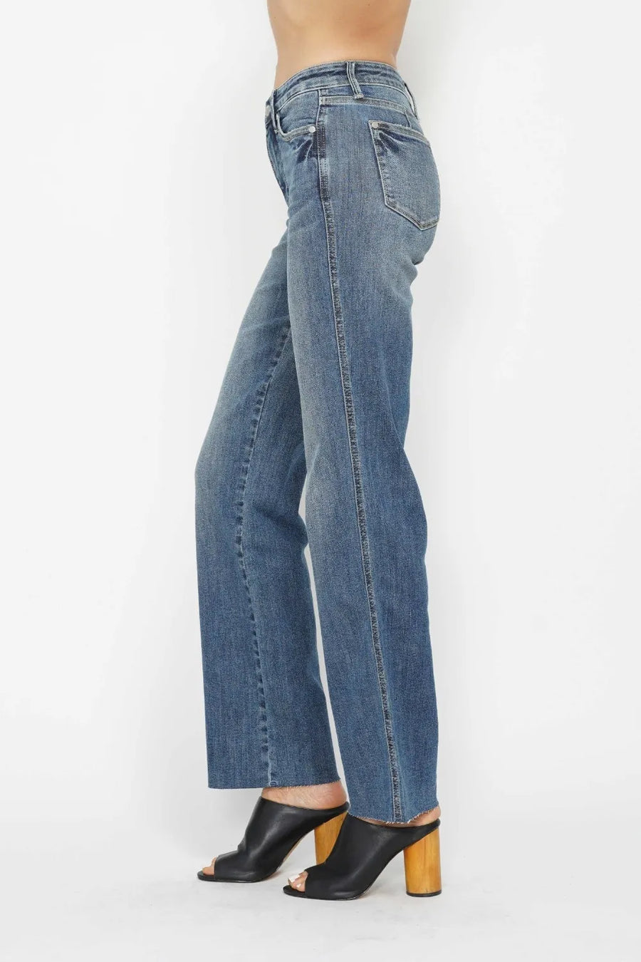 Blue jeans worn by a person on a white background