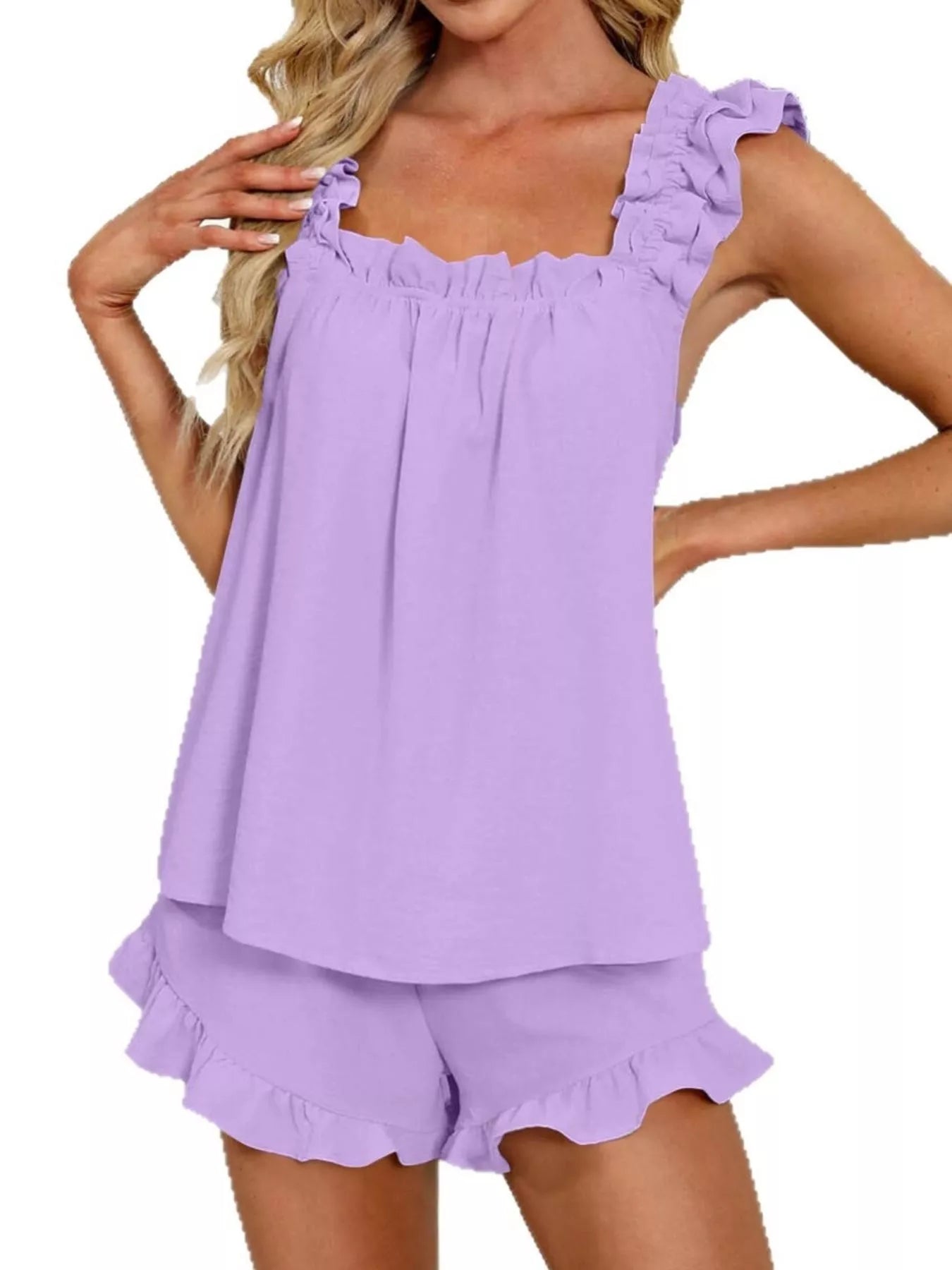 Woman wearing a purple ruffled top and shorts set on a white background
