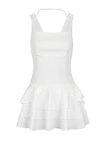 White dress with ruffled layers on a white background