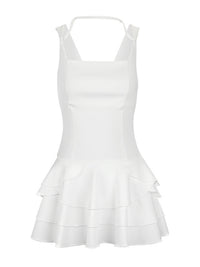 White dress with ruffled layers on a white background