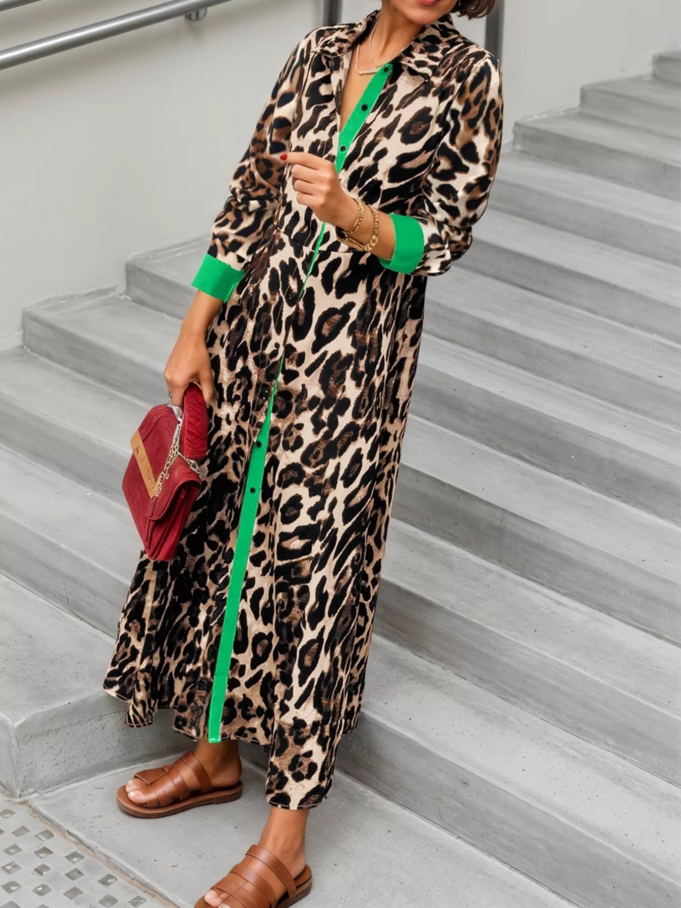 Person wearing a leopard print dress with green accents on a staircase