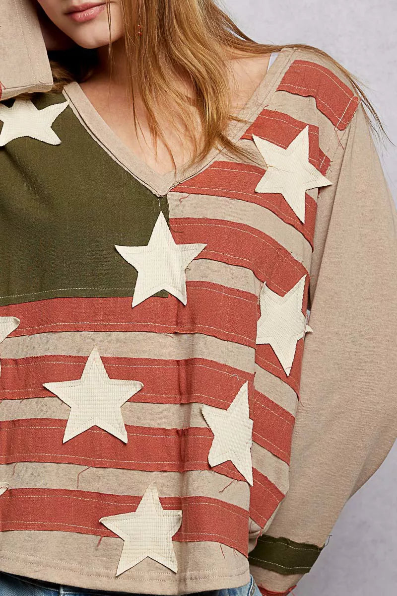 Person wearing a shirt with American flag design and stars