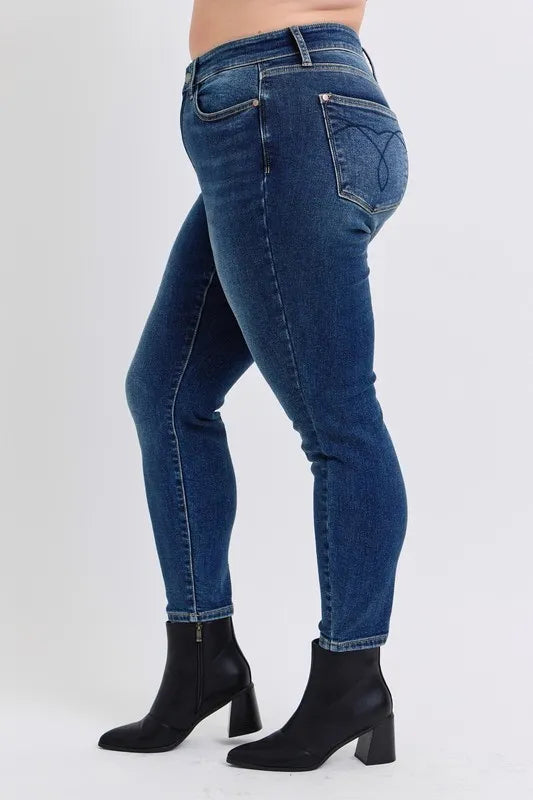Blue jeans worn by a person on a white background