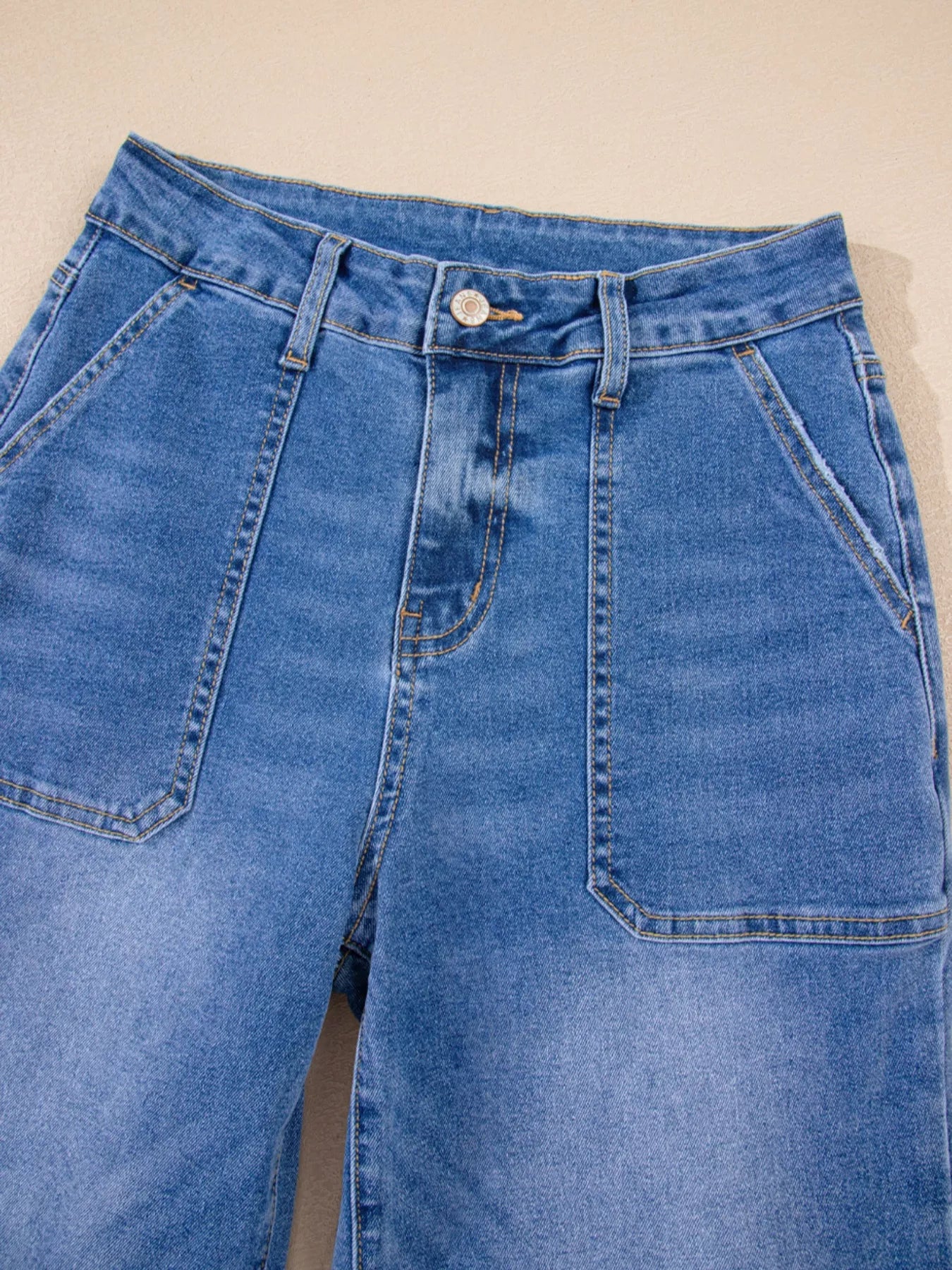 Blue jeans on a beige background