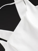 White blouse with thin straps on a black background