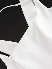 White blouse with thin straps on a black background