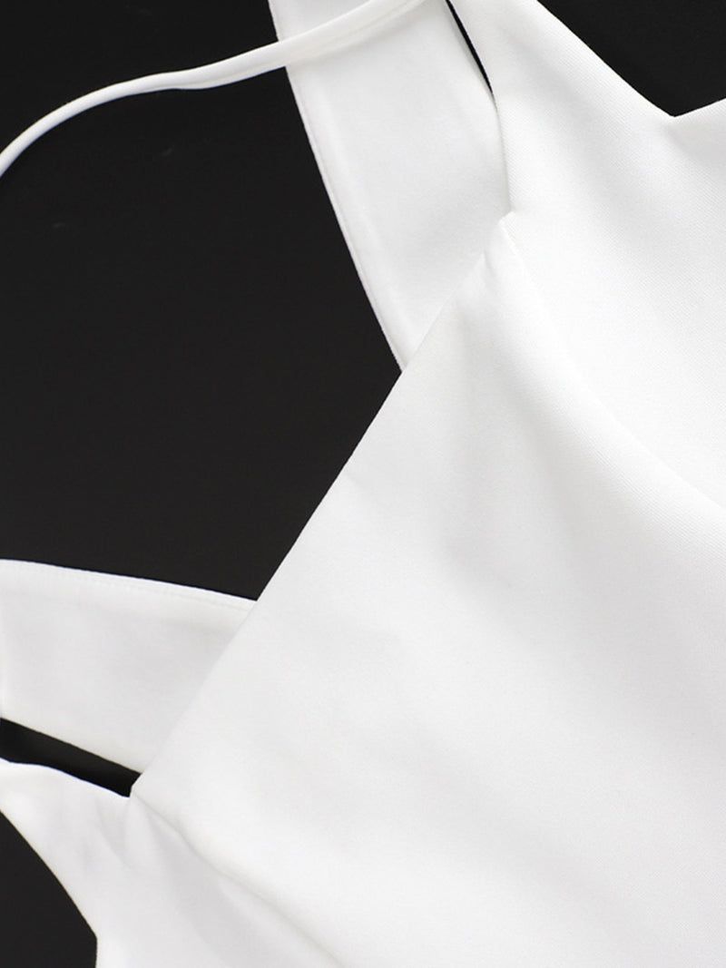 White blouse with thin straps on a black background
