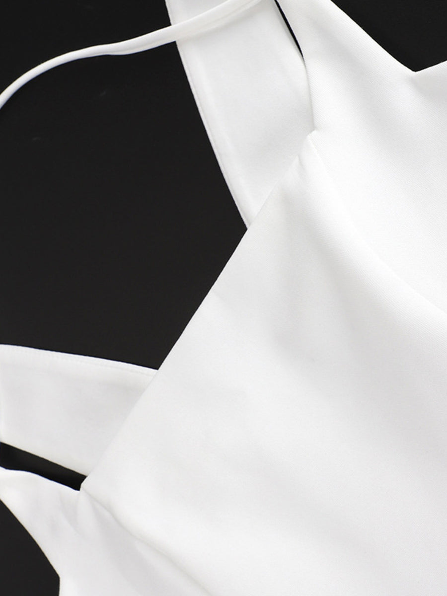 White blouse with thin straps on a black background