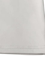 Close-up of a folded light gray fabric with visible stitching on a white background