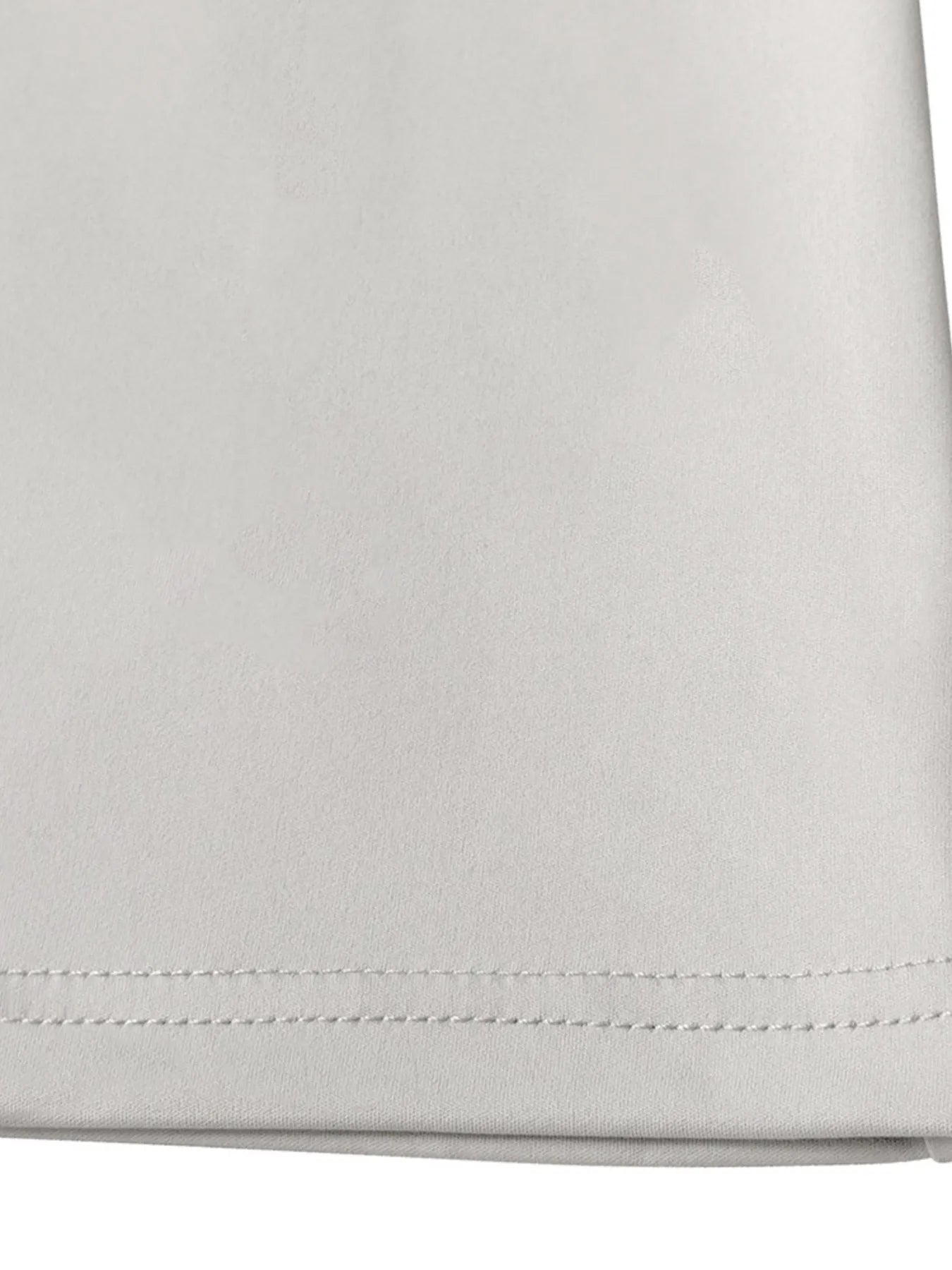 Close-up of a folded light gray fabric with visible stitching on a white background