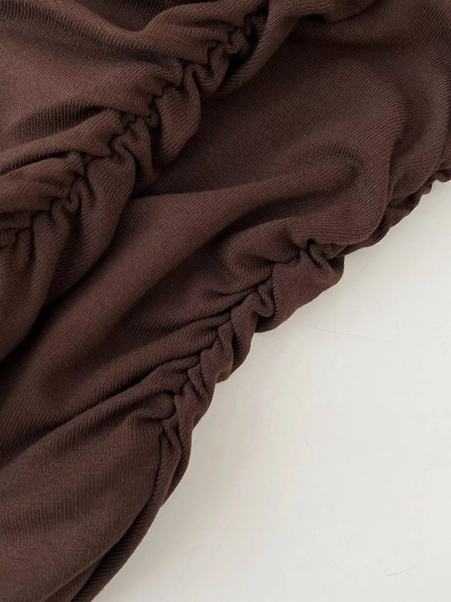 Brown fabric with ruched texture on a white background