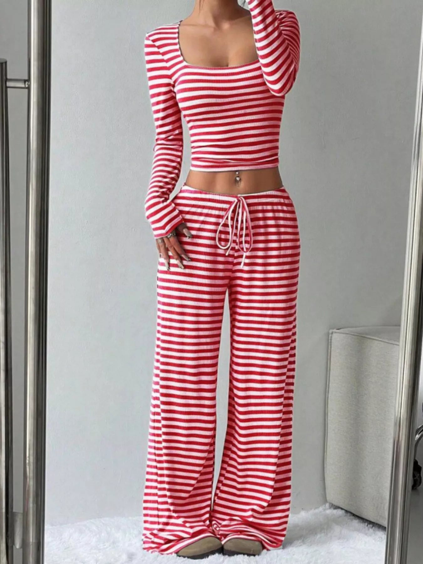 Red and white striped long-sleeve top and wide-leg pants set on a neutral background