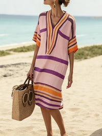 Woman in a colorful striped dress on a beach