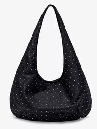 Black shoulder bag with white polka dots on a white background