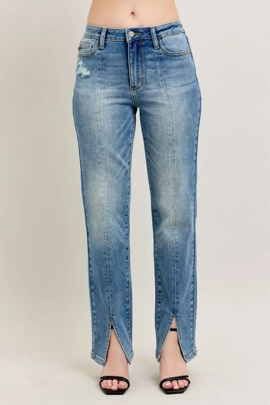 Blue jeans with a slit on a plain background