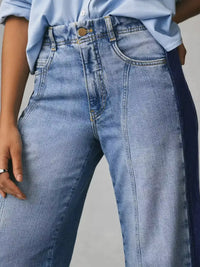 Close-up of blue jeans with a neutral background