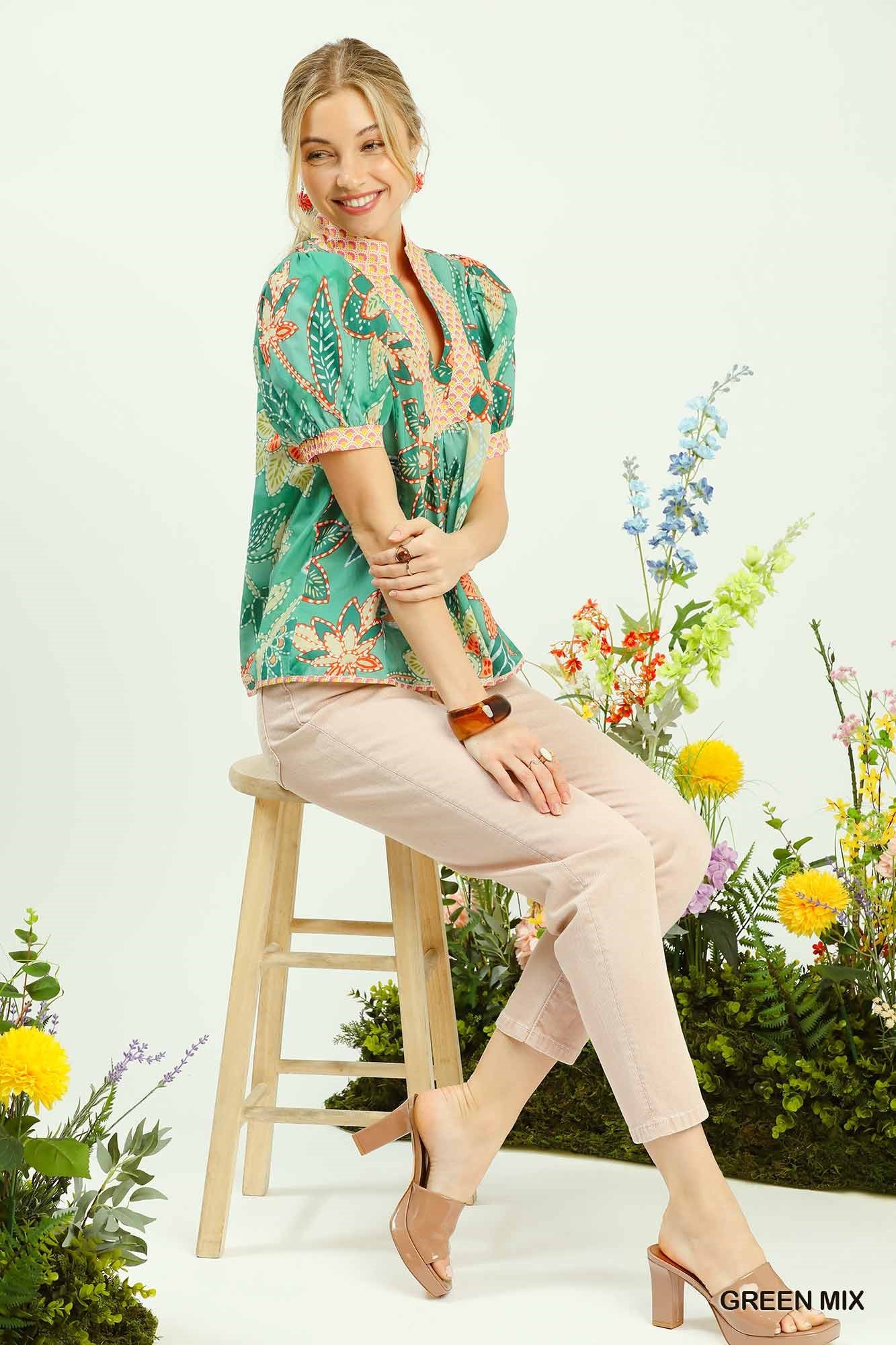 Woman sitting on a stool with floral background and 'Green Mix' text