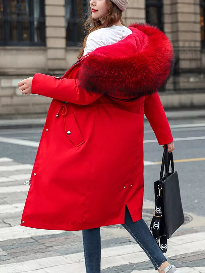 A lady wearing a red Women's Detachable Longline Hooded Parka with Faux Fur Trim and Drawstring Waist off her shoulder.