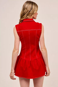 Woman wearing a red dress with a plain background