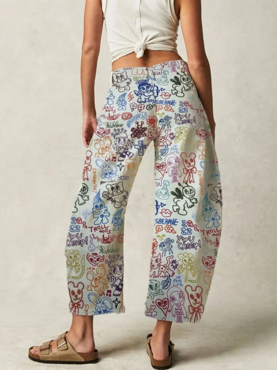 Person wearing colorful patterned pants on a plain background