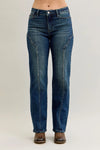 Blue jeans worn by a person on a plain background