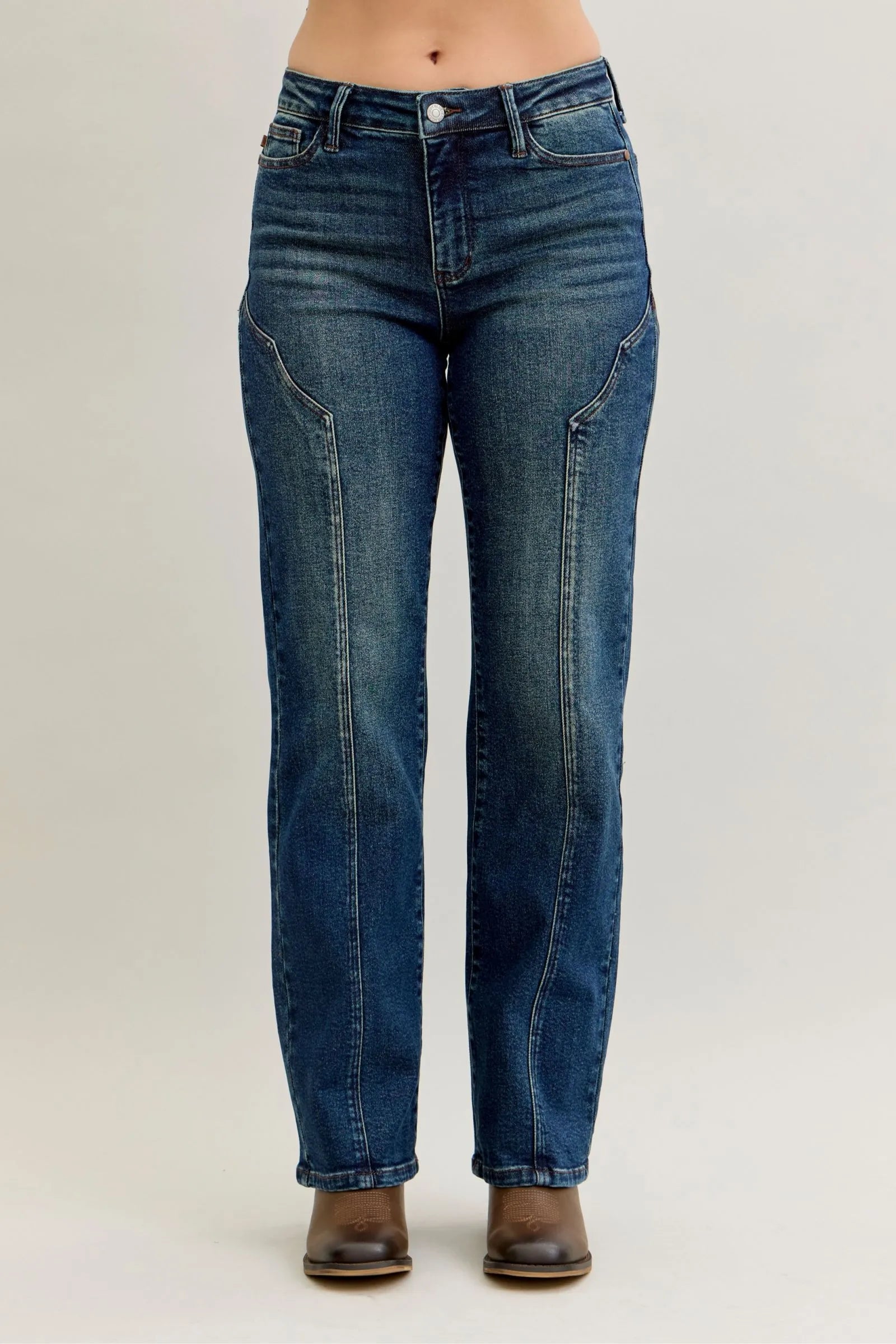 Blue jeans worn by a person on a plain background