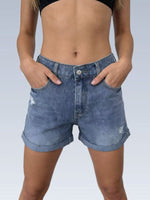 Person wearing blue denim shorts on a plain background