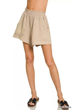Beige checkered skirt worn by a person on a white background