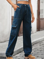 Person wearing blue cargo pants on a street.