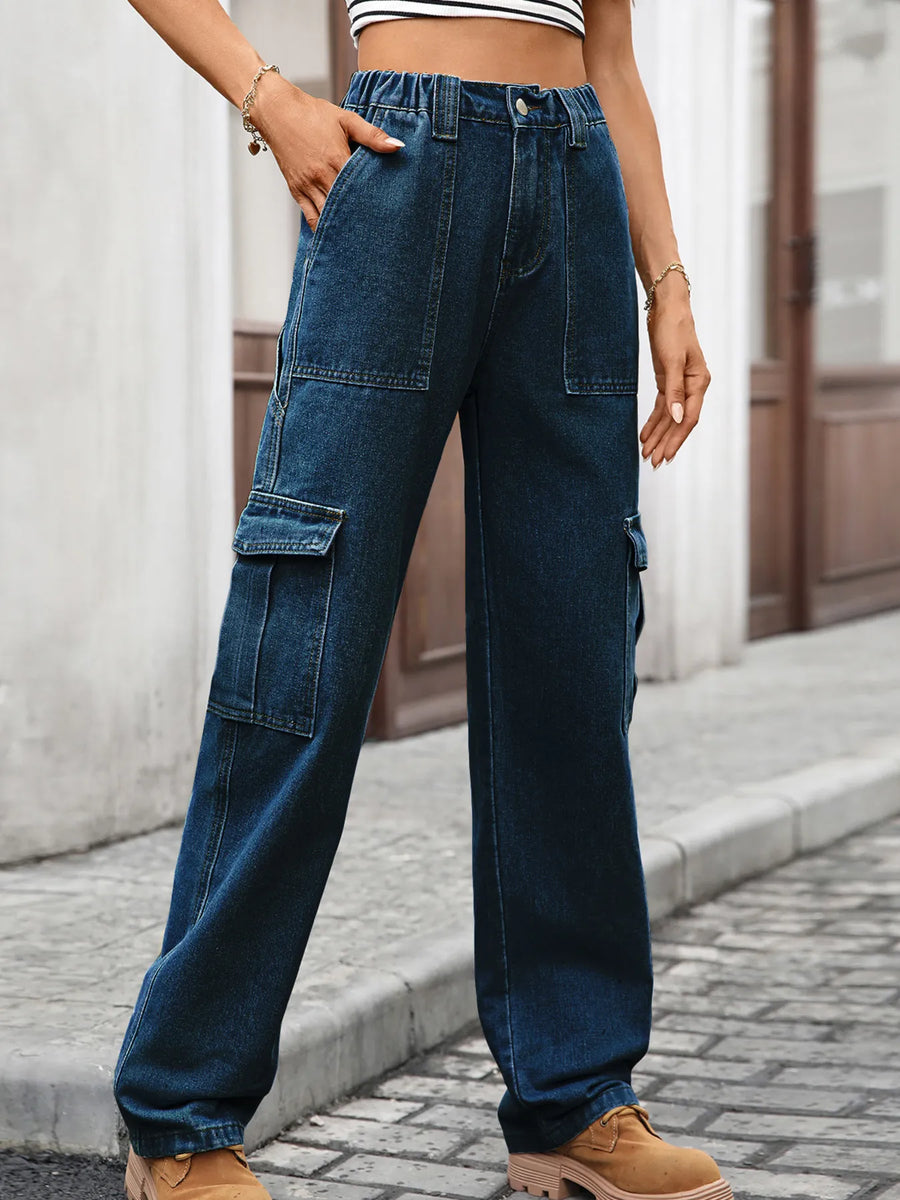 Person wearing blue cargo pants on a street.